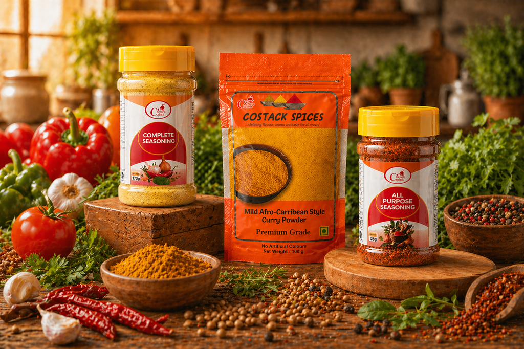 Three spice containers on a wooden surface with fresh vegetables and herbs in the background
